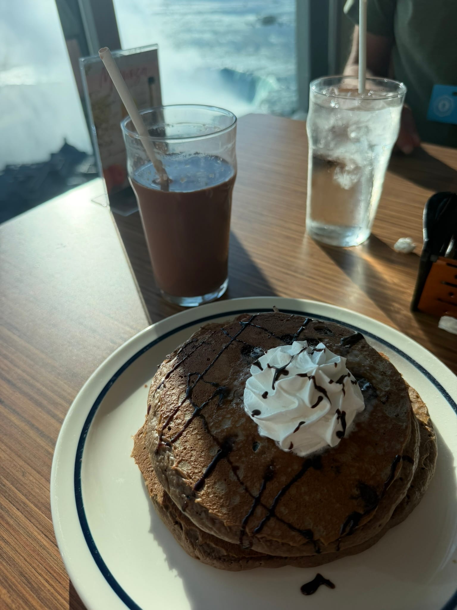 A picture of my chocolate pancakes with the falls blurred in the background.
