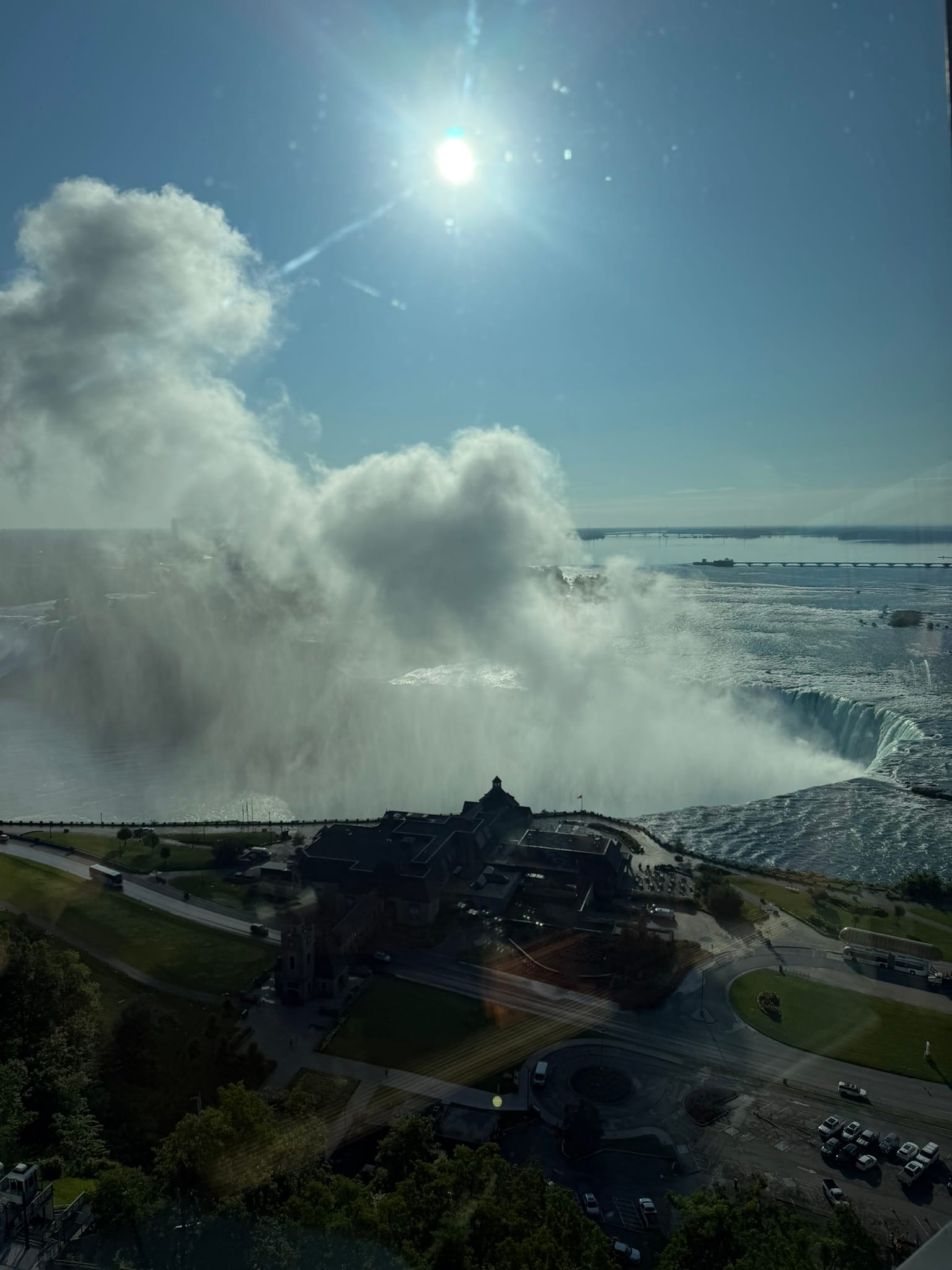 A view of the falls through the window of the IHOP. The mist is level with the tower and the visitor center sits in the show of the mist.
